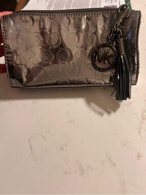 Michael Kors Metallic Pewter Logo Wristlet with Tassel Charm